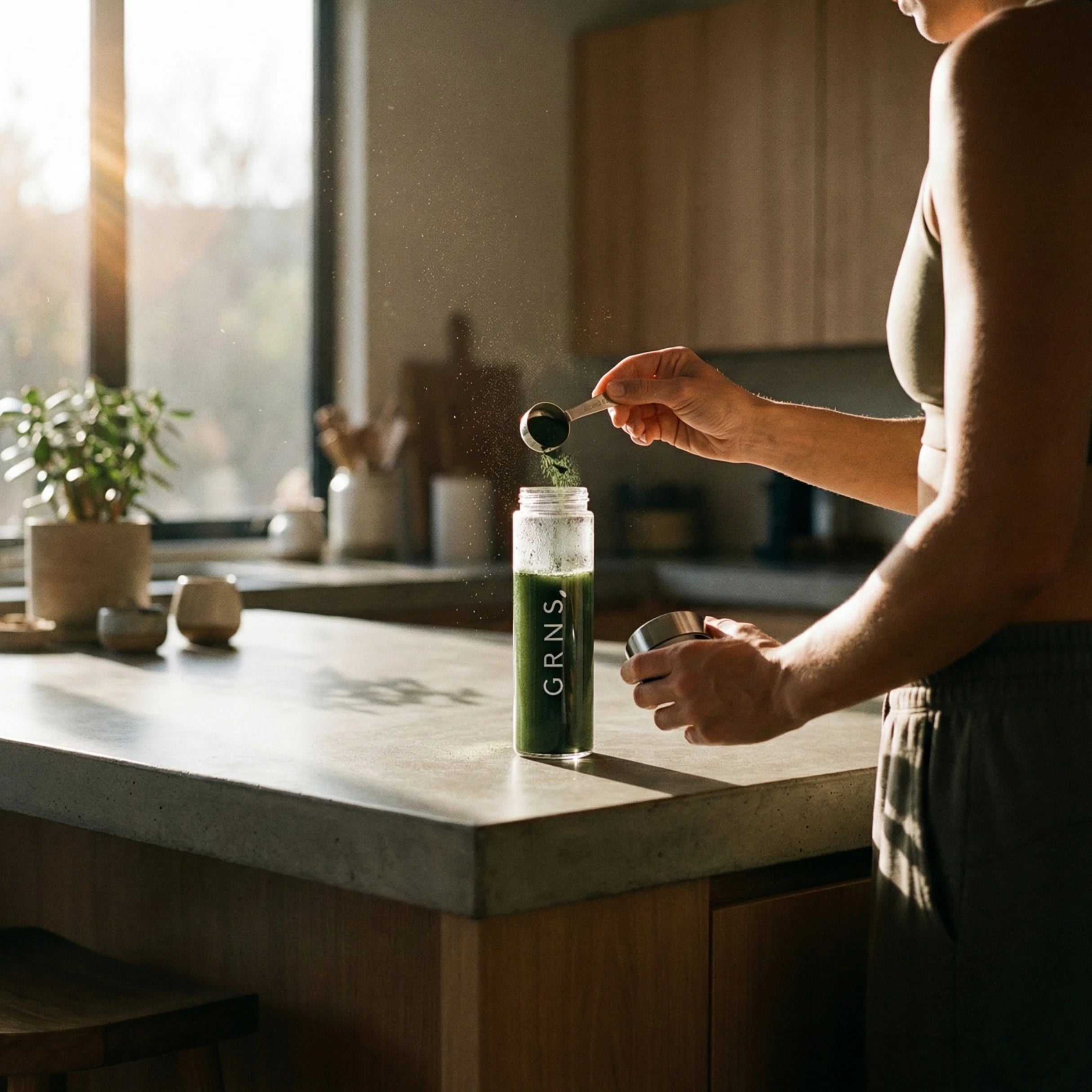 A girl holding a glass of greens pwoder