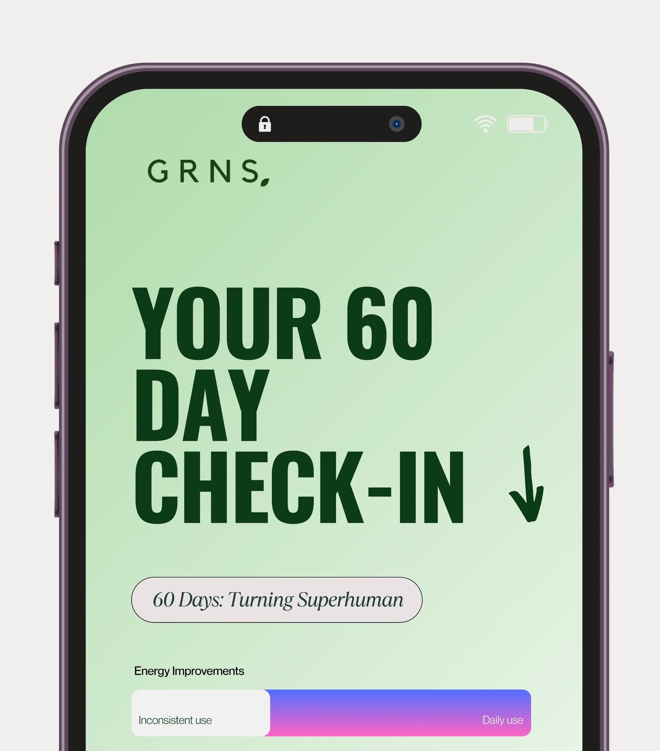 A smiling girl holding a glass of greens powder drink whilst having a green skincare mask on her face