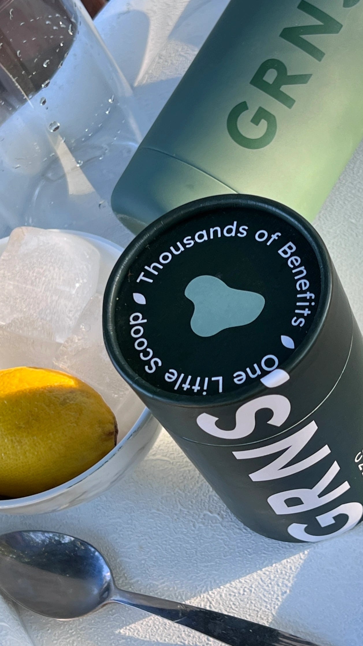 Product shot of GRNS, lemon, and ice